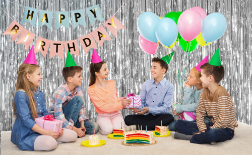 Sparkling silver tinsel backdrop happy banner adults toasting champagne