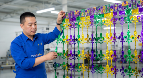 This is our edge reinforcement procedure where our specialist reinforces the top edge of the cut metallic tinsel curtain to maintain alignment across the full width for dependable wholesale consistency.