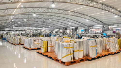 Our workers are working efficiently in the spacious modern warehouse. Large quantities of finished foil fringe curtains have been neatly rolled, carefully wrapped for protection, and stacked on pallets, ready to be shipped to festive celebrations around the world.