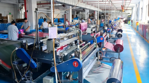 Our workers are busy working on the large-scale automated production line. They collaborate to operate multiple precision machines, feeding, slitting, and processing the metallic foil rolls. The entire production line runs in an orderly manner, with clear division of labor, ensuring every step from raw material to semi-finished products is efficient and stable, providing a high-quality foundation for final assembly.
