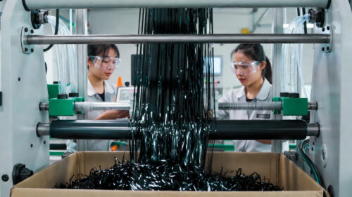 Our workers are closely monitoring the semi-automatic tinsel fringe slitting machine, observing the cutting process in real time to ensure the metallized black PET film is precisely cut into dense, uniform metallic fringe strips that fall naturally into the collection box, with smooth, burr-free edges throughout.